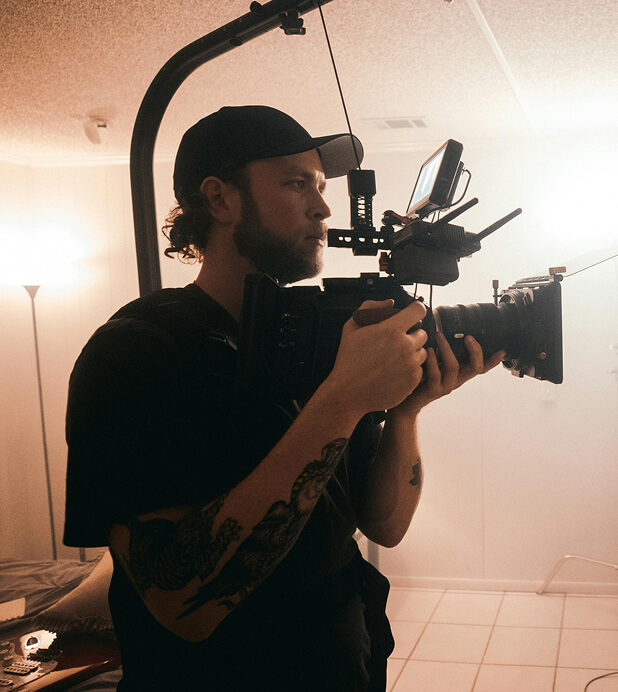 Cinematographer operating a camera rig on set.